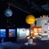 An exhibit at the International Antarctic Centre featuring hanging models of Earth and the sun along with displays showcasing Antarctica